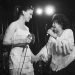 Imelda May and Wanda Jackson holding hands on stage at a gig