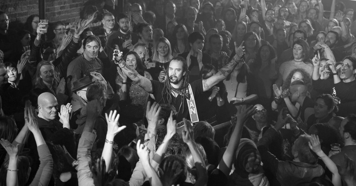 Michael Franti performing from the crowd at his gig in London in 2016