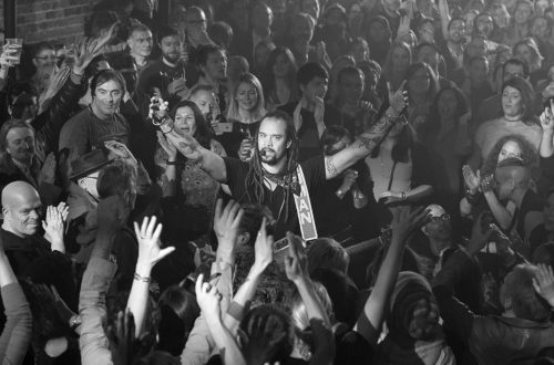Michael Franti performing from the crowd at his gig in London in 2016